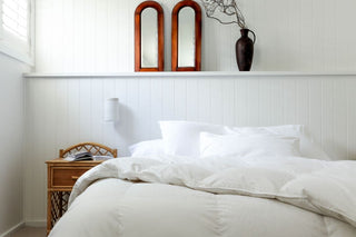 sienna living white duck down feather quilt open on top of bed in white room
