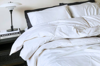 white duck feather quilt folded out on bed