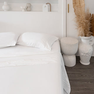 sienna living bamboo white sheet set on bed with cement stool beside bed