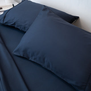 Plush and inviting Sienna Living dark nights pillowcases on a well-made bed.