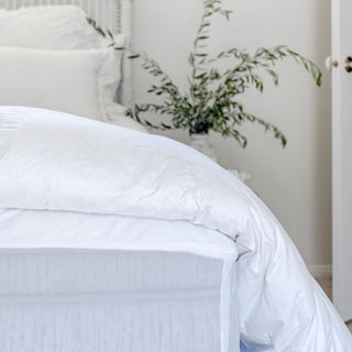 Close up Ultra-Warm Hungarian Goose Down doona  in white; Cozy winter quilt on a bed.